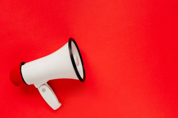 istock White megaphone on red background. Alarm and announcement 1464508311