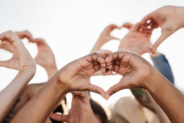 istock Crowd, motivation and hearts hands in air, support and solidarity for equal human rights, hope together and emoji for care. Community with sign, love and peace with collaboration, harmony and growth 1464509552