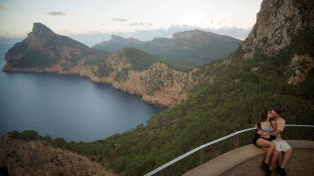 istock Romantic summer. Couple on vacations visiting a viewpoint and watching the sights below. Kissing 1464512301