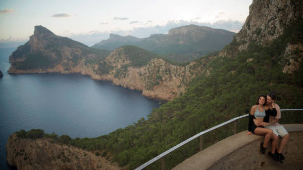 istock Romantic summer. Couple on vacations visiting a viewpoint and watching the sights below. Embracing 1464512302