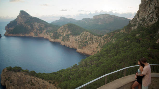 istock Romantic summer. Couple on vacations visiting a viewpoint and watching the sights below. Kissing 1464512304