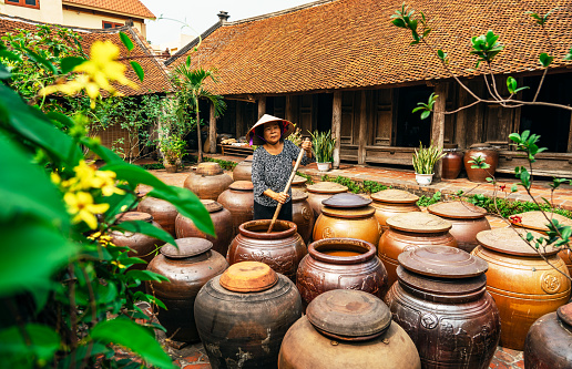 Jars of Tuong in ancient house yard, a kind of fermented bean paste made from soybean and commonly used in Vietnamese cuisine