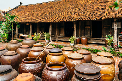 Jars of Tuong in ancient house yard, a kind of fermented bean paste made from soybean and commonly used in Vietnamese cuisine