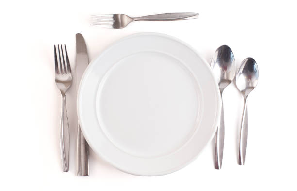 istock A Table Set with a Clean and Emtpy White Set of Dishes and Silverware 1464514292