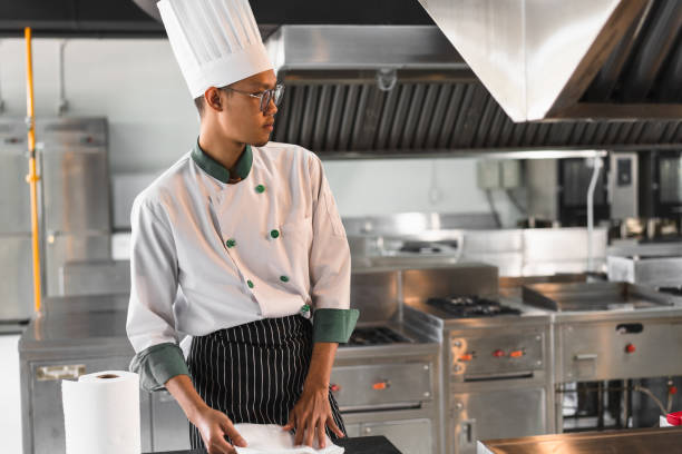 istock Portrait Asia young man in chef uniform at kitchen 1464514348