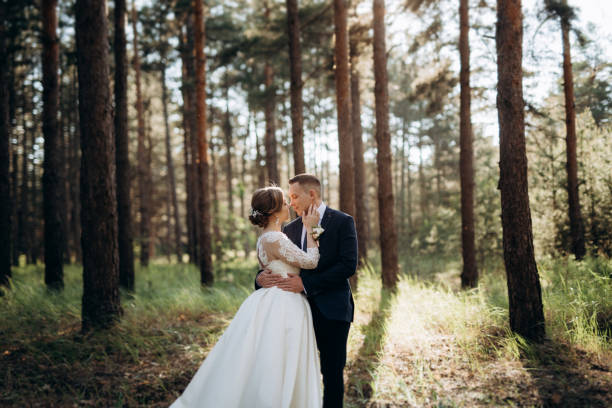 istock the bride and groom are walking in a pine forest 1464514537
