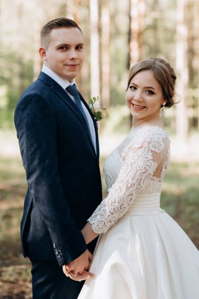 istock the bride and groom are walking in a pine forest 1464515159
