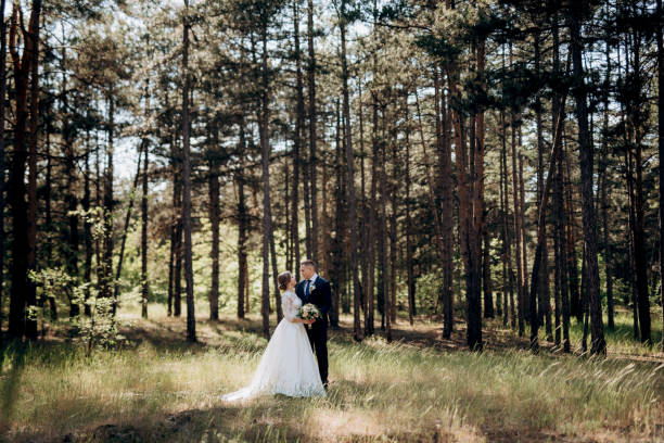 istock the bride and groom are walking in a pine forest 1464515791