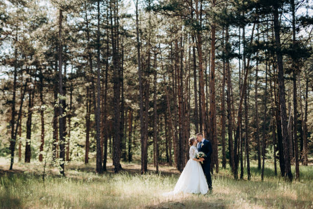 istock the bride and groom are walking in a pine forest 1464516048