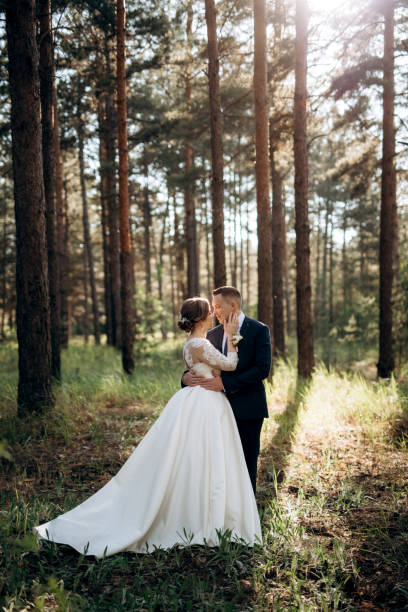 istock the bride and groom are walking in a pine forest 1464516789