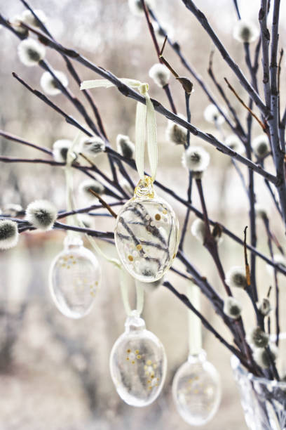 istock Bunch of willow sprigs decorated for Easter with decorative glass Easter eggs, rustic style. 1464517408