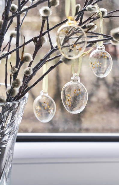 istock Bunch of willow sprigs decorated for Easter with decorative glass Easter eggs, rustic style. 1464517415