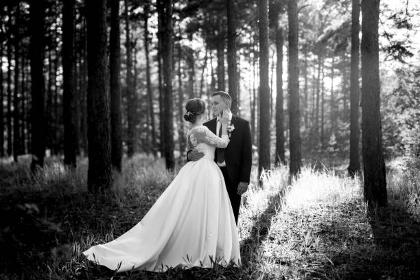 istock the bride and groom are walking in a pine forest 1464517791