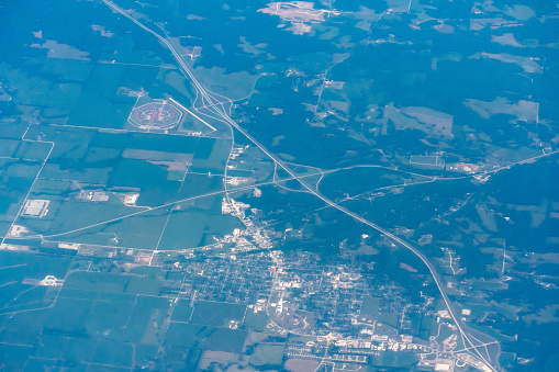 An aerial view of an intersecting freeways out side of a midwestern town