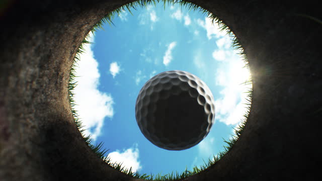 Golf Ball Falling Down into the Hole on Golf Course After Accurate Shot in Slow Motion Close-up. Putting Ball Towards Camera Inside Hole Beautiful 3d Animation. Sport Concept