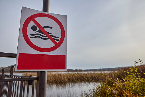 Signs posted at the end of the swimming season stating that swimming is prohibited. Signs are removed at the beginning of the swimming season.