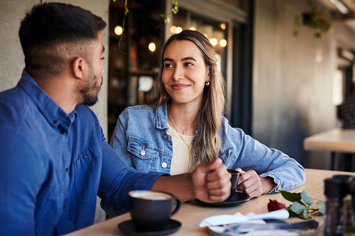 Relax, smile and coffee with couple in cafe for celebration, valentines day and romance date. Latte, love and happy with man and woman in restaurant for retail, bonding and quality time together