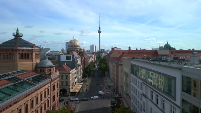 Landmark tower centered in the middle. Buttery soft aerial view flight pull in drone over a road in Berlin city Oranienburger street summer 2022. 4k marnitz cinematic