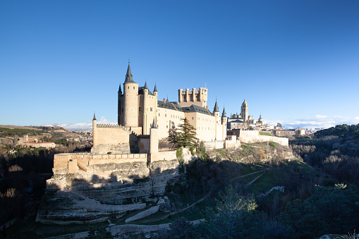 Exterior view of the Alcazar of Segovia, Spain. Tourists on the way visiting the Castle.