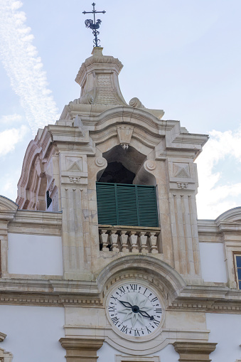 Ancient clock tower with weather vane in Coimbra