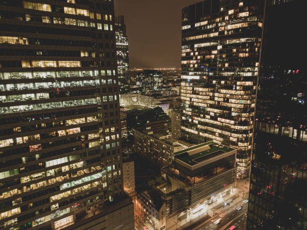 istock Office building still operate at very late night with many office worker doing part time work. Salary man overworking issue concept in urban of countries and urban night skyline. 1464534784