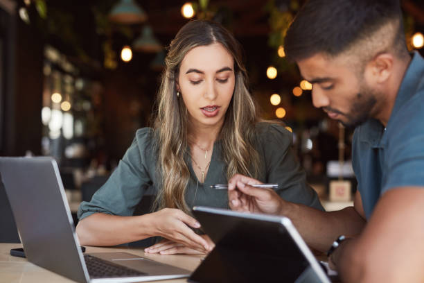 istock Thinking business people, technology or talking in cafe collaboration on website branding, logo or planning. Man, woman or creative teamwork pointing at paper documents in remote working restaurant 1464536826