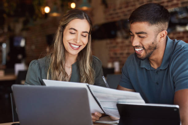 istock Collaboration, technology or reading documents in cafe, coffee shop or restaurant of startup budget, loan or investment. Happy, smile or business people and paper, strategy planning or remote working 1464536833