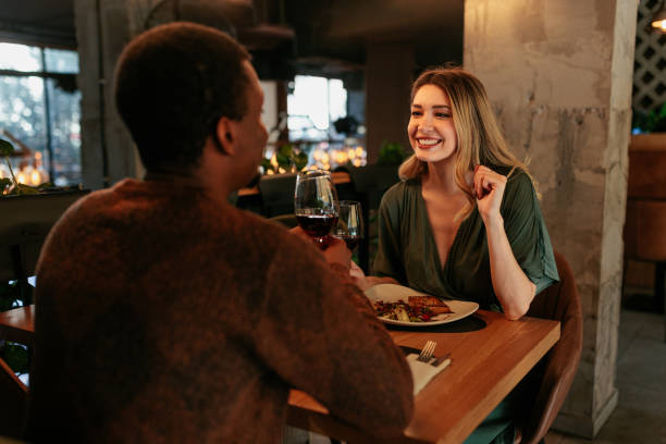 happy woman on date with boyfriend. - dating restaurant dinner couple imagens e fotografias de stock