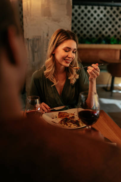 istock Woman enjoying dinner in restaurant. 1464538867