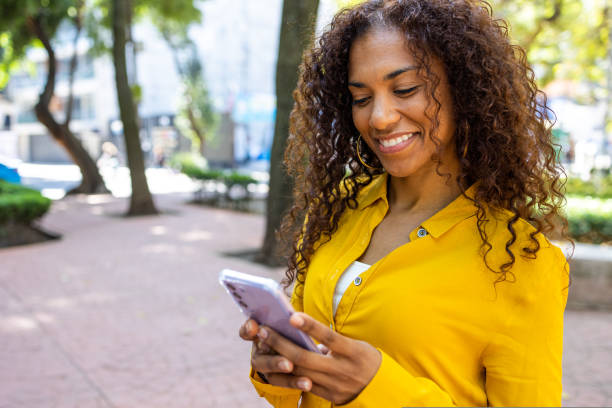 istock Latin woman using mobile phone 1464539310