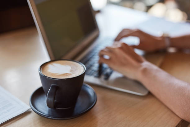 istock Coffee cup, cappuccino or hands typing on laptop in cafe or restaurant for university, college or school studying. Zoom, drink or beverage for student woman on technology for research in remote work 1464539556