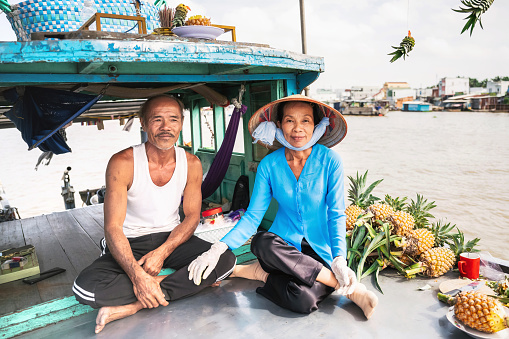 Damnoen Saduak, Thailand - June 19, 2018: Floating market with fruits, vegetables and different items sold from small boats, in Damnoen Saduak, Thailand