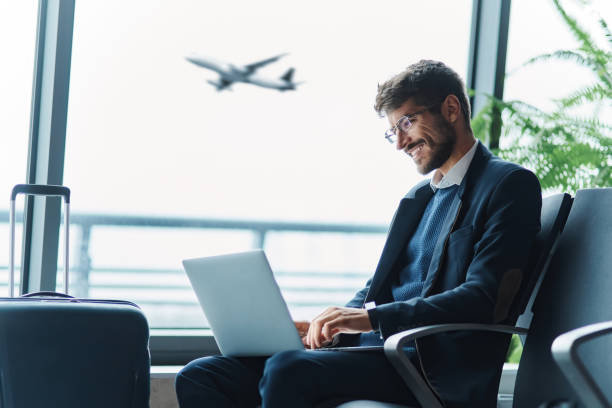 istock tired passenger using a laptop in the waiting room . 1464540058