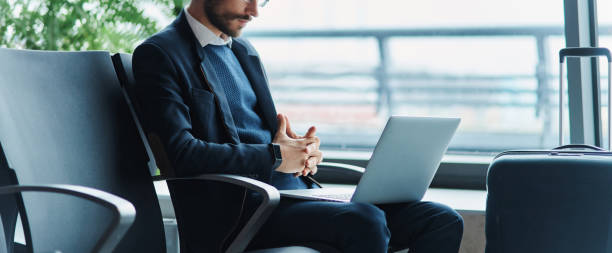 istock business man using his laptop during a business trip. 1464540191