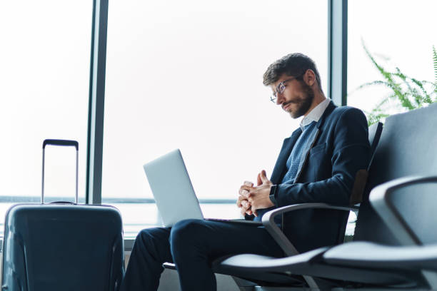 istock business man using his laptop during a business trip. 1464541019