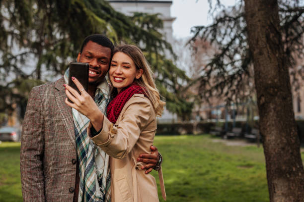 istock Happy couple taking selfie outside. 1464541029