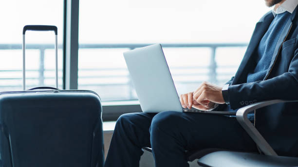 istock business man using his laptop during a business trip. 1464541131