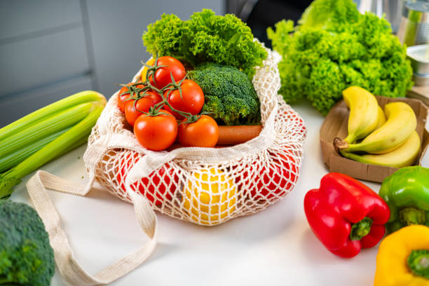 istock Reusable mesh shop bag with fresh produce on kitchen counter 1464543219