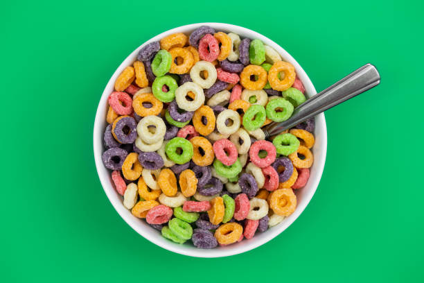 istock Colored breakfast cereal in a bowl on a green background, flat lay. 1464547603