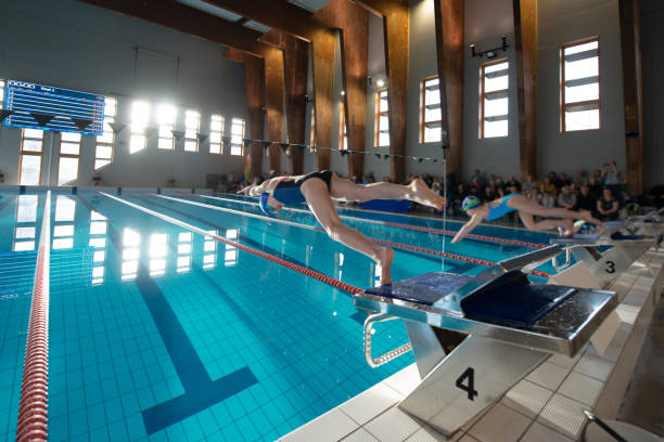 istock Swimmer girl start from the starting table in the pool 1464548810