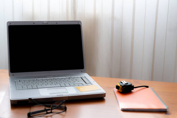 istock Laptop computer on a wooden desk 1464550362