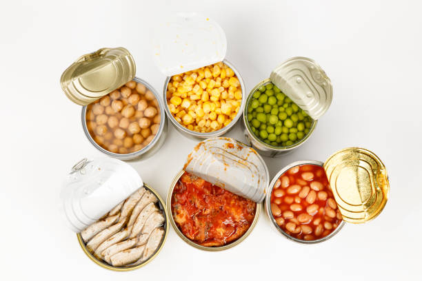 Variety of canned fish and vegetables on a white background.