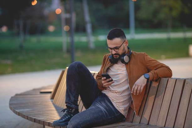 istock Man using phone on city street. 1464552622