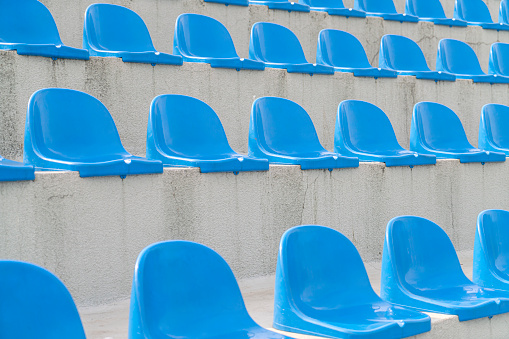 Blue stadium chairs in an empty stadium