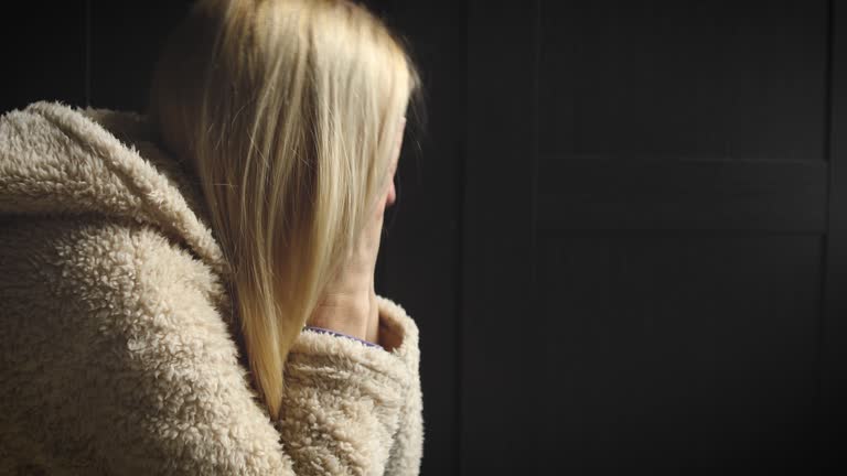 Upset Woman Crying as She Hides Behind Hair