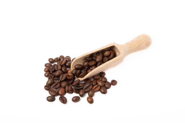 istock Coffee beans in wooden spoon isolated on white background. 1464559571
