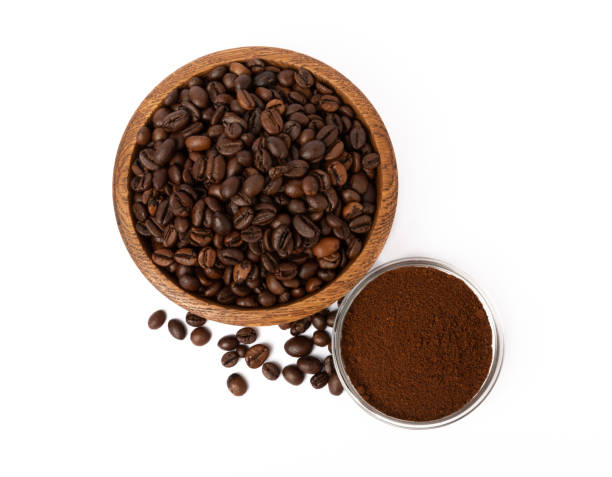istock Bowl of ground coffee and beans isolated on a white background. 1464559604