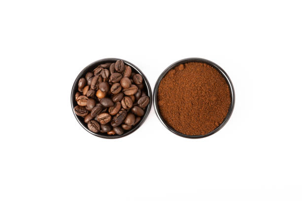 istock Bowl of ground coffee and beans isolated on a white background. 1464560023