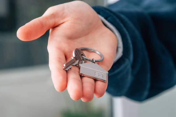 istock hand with keys and keychain from house or apartment 1464561868