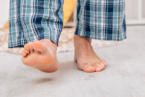 istock bare feet walking on the floor at home 1464561896